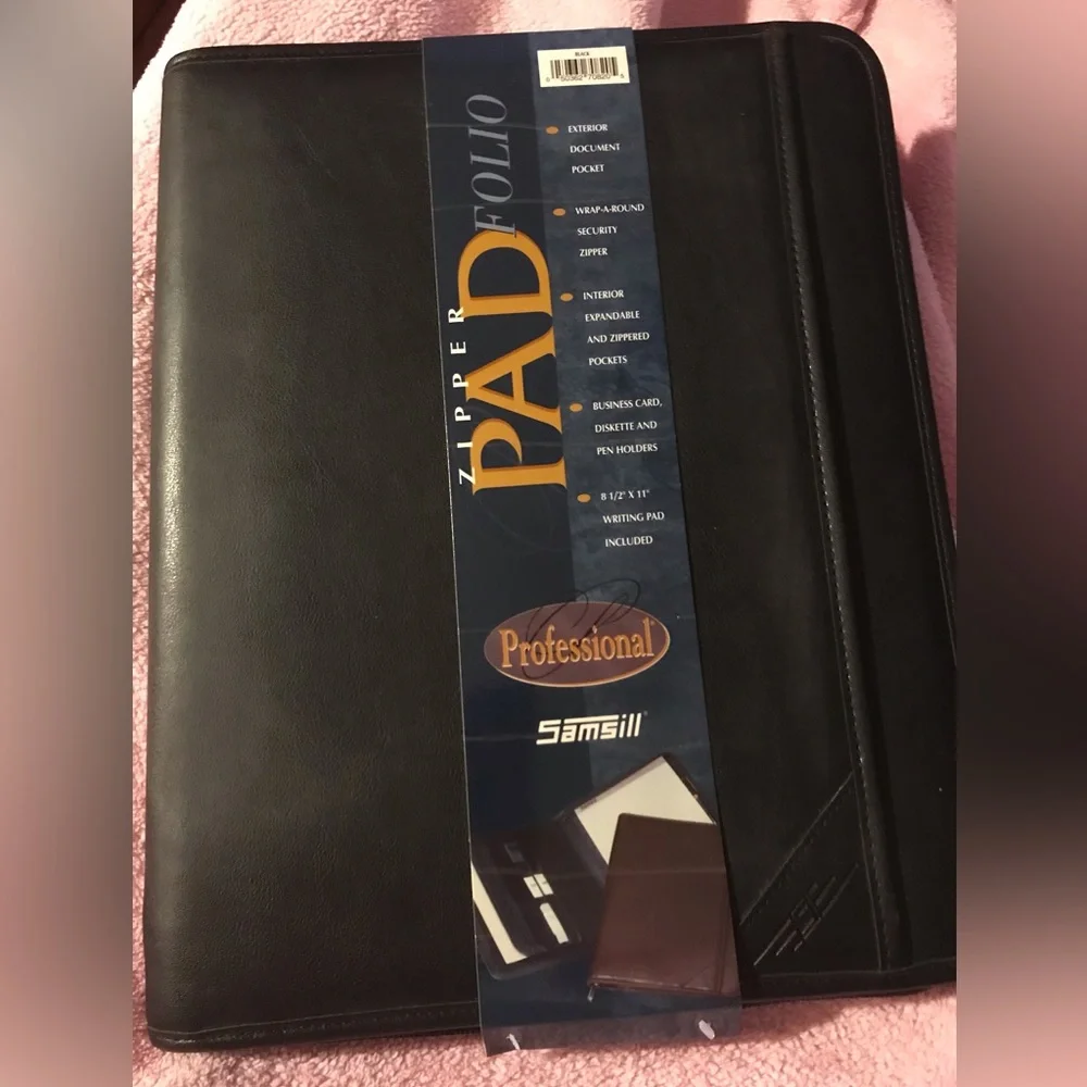 Black portfolio with wraparound zipper. Writing pad, slide and zippered pockets.